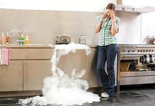 woman calling plumber with overflowing sink 